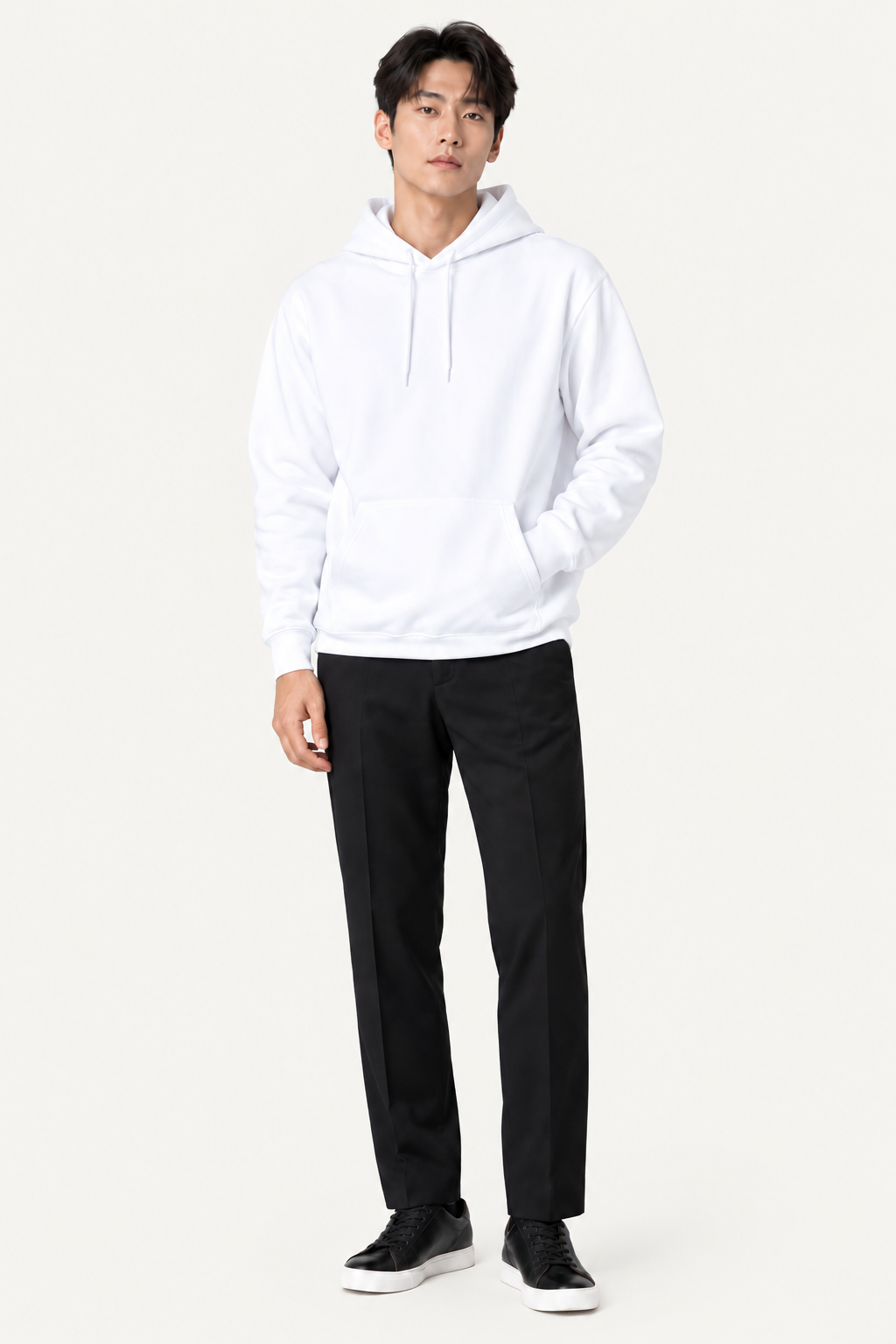 Man wearing a white hoodie and black trousers
